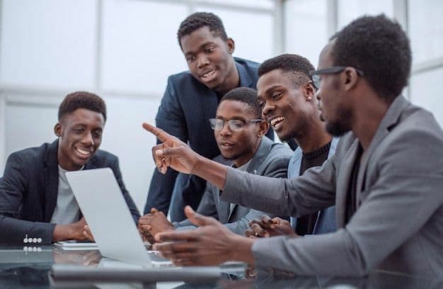 Colleagues gathered around a laptop