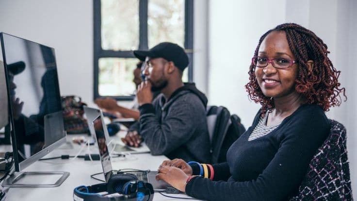 Smiling at a desk in a shared office